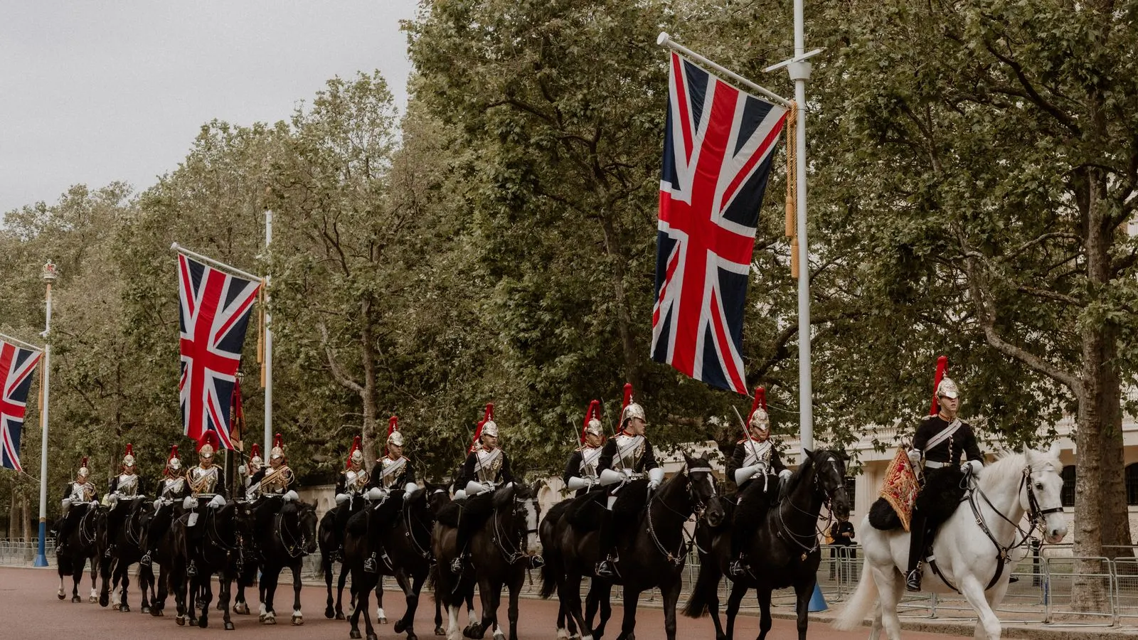 Union Jack flags line The Mall in London, leading to Buckingham Palace.